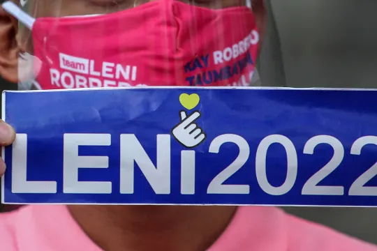 A man holds signage supporting Philippine Vice President Leni Robredo on her candidacy to join the 2022 presidential race outside the Cultural Center of the Philippines in Pasay, Metro Manila on October 7, 2021.