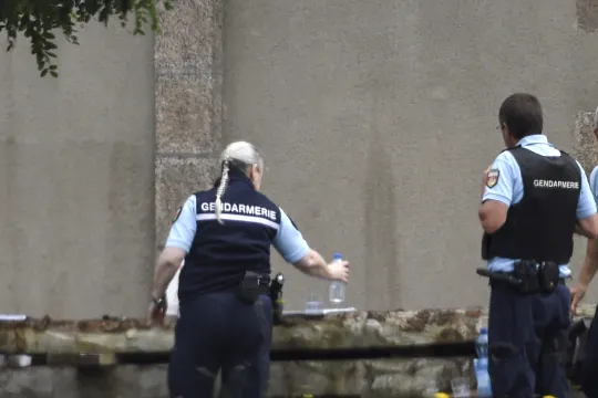 French gendarmes gather at the place where a French catholic priest, aged 60, has been murdered in Saint-Laurent-sur-Sevre, Western France, on August 9, 2021. The murderer, a Rwandan refugee suspected of causing a major fire that ravaged the cathedral in the French city of Nantes in 2020 and who had been welcome into his church by the priest for several months, was already under judicial control over the fire at Nantes cathedral in July 2020, the Interior minister and a source close to the investigation sai