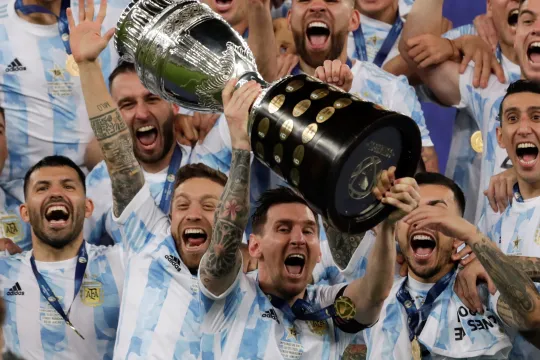 Argentina's Lionel Messi (C) celebrates with the Copa America trophy after the Copa America 2021 final between Argentina and Brazil at the Maracana Stadium in Rio de Janeiro, Brazil, 10 July 2021. 
