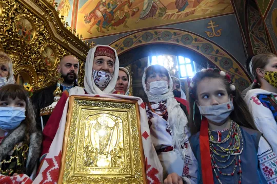 Orthodox Christian followers take part in the Orthodox Easter service in Mykhaylo Gold Domes cathedral in Kiev on May 2, 2021. Sergei SUPINSKY / AFP