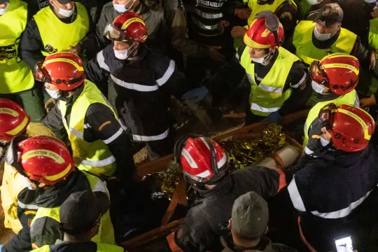 Moroccan emergency services teams carry five-year-old Rayan Oram 