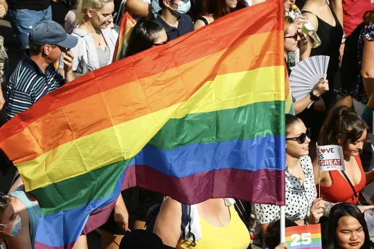 A participant waves a rainbow flag during the lesbian, gay, bisexual and transgender (LGBT) Pride Parade in Budapest on July 24, 2021. 