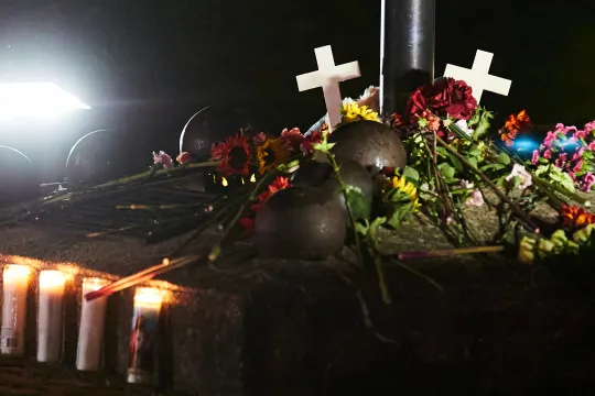 A makeshift memorial is pictured during a candle light vigil in Cutler Park in Waukesha, Wisconsin on November 22, 2021, the day after a vehicle drove through a Christmas parade killing five people. US authorities identified the driver suspected of plowing into a Christmas parade in the Midwestern city of Waukesha, killing at least five and wounding dozens, as media reported he was fleeing a knife fight. The Sunday evening chaos in Wisconsin, which saw a red SUV speed into a crowd of men, women and children