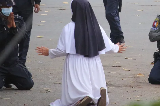 nun pleading with police not to harm protesters in Myitkyina in Myanmar's Kachin state, amid a crackdown on demonstrations against the military coup.  Handout / Myitkyina News Journal / AFP