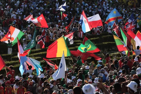 Participants wave flags during the welcoming ceremony of World Youth Day (WYD) gathering of young Catholics, at Eduardo VII Park in Lisbon on August 3, 2023. Pope Francis today urged young people to focus on caring for the planet and fighting climate change, calling for an "integral ecology" that melds environmental protection with the fight against poverty and other social problems. Around one million pilgrims from around the world will attend the World Youth Day, the largest Catholic gathering in the worl