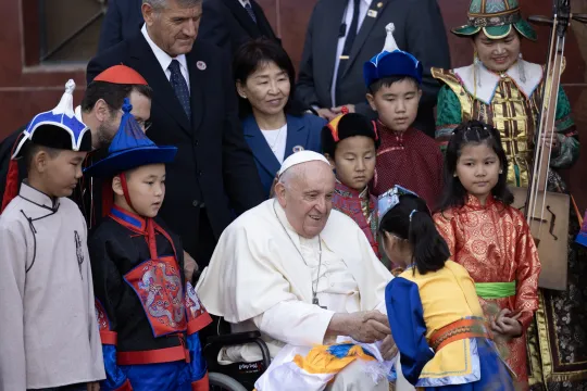 Pope Francis (C) greets a child as he attends a welcoming ceremony at the Apostolic Nunciature to Mongolia in Ulaanbaatar on September 1, 2023. Anand TUMURTOGOO / AFP