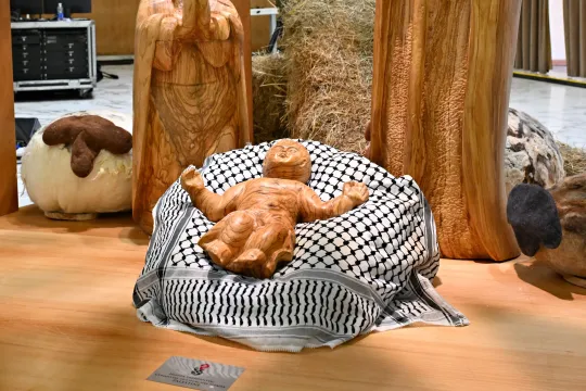 This photograph shows the "Christ Child" displayed on a keffiyeh scarf gifted by the Palestinian Higher Committee of Churches Affairs, as part of the "Nativity of Bethlehem 2024" during its inauguration in the Paul VI Hall, during the private audience to donors of the Nativity Scene and the lighting of the Christmas tree ceremony at St Peter’s Square in the Paul-VI hall at the Vatican on December 7, 2024. Andreas SOLARO / AFP
