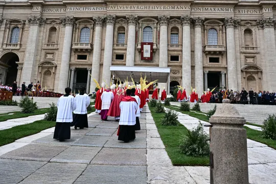 Celebrants and cardinals walk in procession during a mass for Palm Sunday in St Peter's square in the Vatican on April 13, 2025. Tiziana FABI / AFP