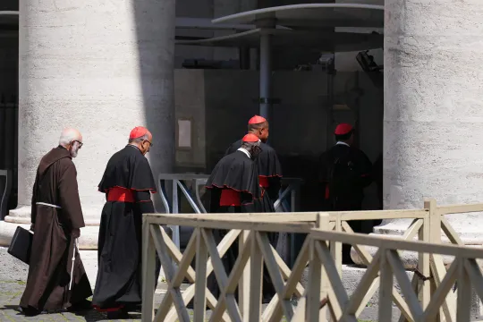 Spanish Cardinal Celestino Aos Braco (L), Chilean Cardinal Fernando Natalio Chomali Garib and fellow cardinals walk through a security check gate at The Vatican, on April 30, 2025. Dimitar DILKOFF / AFP