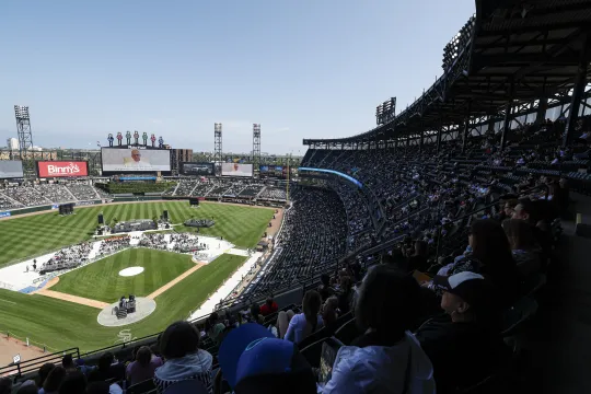 Catholic faithful watch a message from Pope Leo XIV broadcasted on a giant screen during a celebration held in his honor at Rate Field, home of the MLB’s White Sox, in Chicago, Illinois on June 14, 2025. KAMIL KRZACZYNSKI / AFP