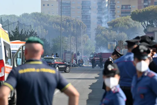 Firemen, policemen and rescue teams work on the site of an explosion in a fuel station in Rome on July 4, 2025. At least ten people were injured in an explosion with the blast heard across the Italian capital. Neighbouring buildings were evacuated following the explosion, which occurred shortly after 8am during what media reports said was a refueling operation.  Andreas SOLARO / AFP