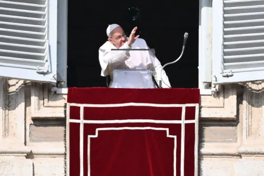 Pope Francis waves from the window of the apostolic palace overlooking St. Peter's square during the Angelus prayer on January 28, 2024 in The Vatican. Alberto PIZZOLI / AFP