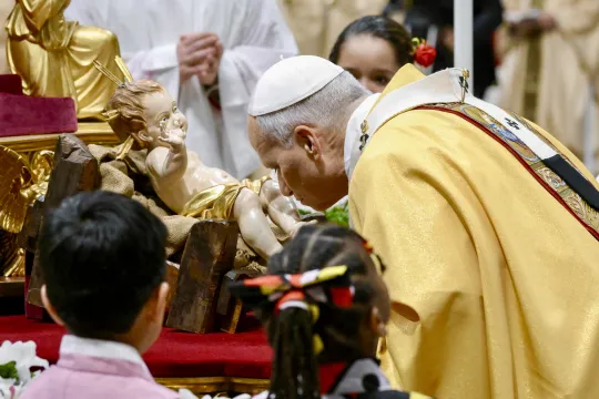 This handout photo provided on December 24 2025 by Vatican Media shows Pope Leo XIV kissing the statue of Baby Jesus at the end of the Christmas Eve mass at St Peter's Basilica at the Vatican. Mario Tomassetti / VATICAN MEDIA / AFP