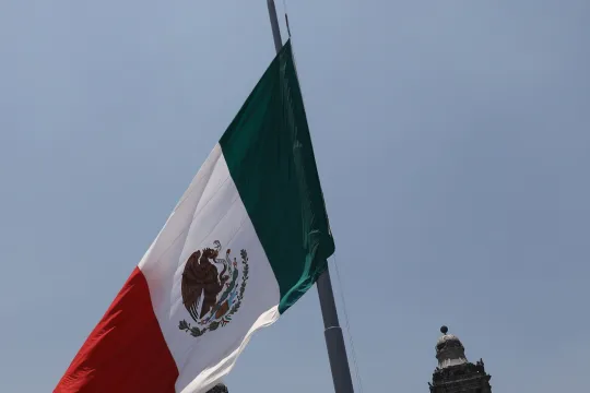 View of the Zocalo Square with the Mexican flag at half mast, as a sign of mourning for the at least 23 fatalities of the accident on Metro Line 12 on the night of 03 May, in Mexico City, Mexico, 04 May 2021. The Government of Mexico City raised the Mexican flag at half mast in the Zocalo and in the official buildings this Tuesday, after the accident that at the moment leaves 23 people dead and more than 70 injured due to the collapse of a structure on Line 12 of the subway. 