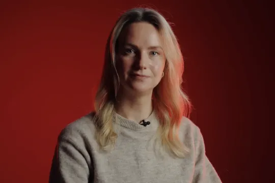 Blonde vrouw met rode achtergrond