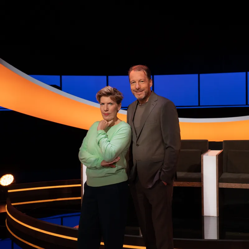 Man en vrouw lachend in een studio