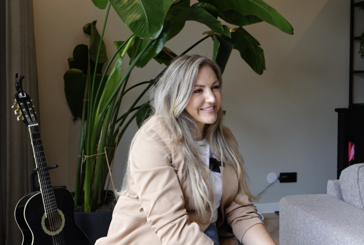 Lachende blonde vrouw in een woonkamer