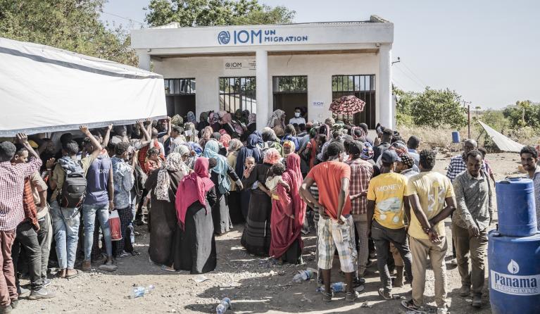 Refugees who crossed from Sudan to Ethiopia wait in line to register at IOM (International organization for Migration) in Metema, on May 4, 2023. More than 15,000 people have fled Sudan via Metema since fighting broke out in Khartoum in mid-April, according to the UN's International Organization for Migration, with around a thousand arrivals registered per day on average. Amanuel Sileshi / AFP