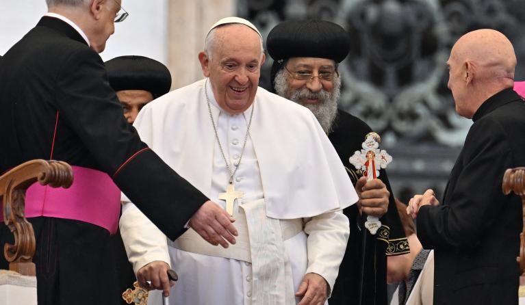Pope Francis (R) speaks with Leader of the Coptic Orthodox Church of Alexandria, Pope Tawadros II (Pope Theodore II) during the weekly general audience on May 10, 2023 at St. Peter's square in The Vatican. Filippo MONTEFORTE / AFP 