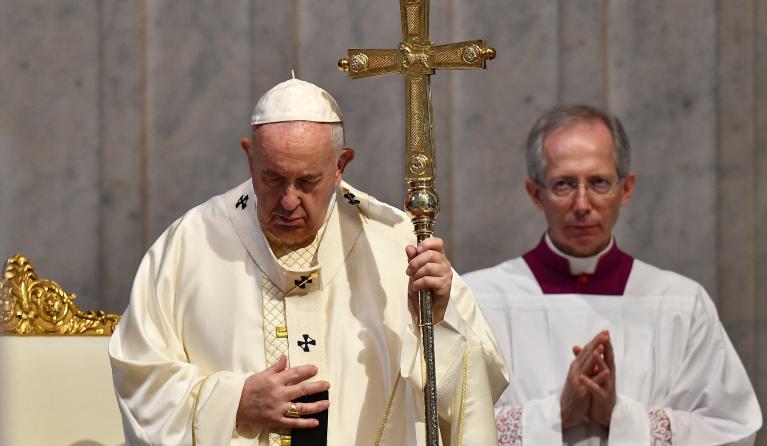 Pope Francis, assisted by Master of Pontifical Liturgical Ceremonies, Italian priest Guido Marini, holds a Holy Mass on the Solemnity of the Most Holy Body and Blood of Christ, on June 14, 2020 at St. Peter's Basilica in The Vatican, as the city-state eases its lockdown aimed at curbing the spread of the COVID-19 infection, caused by the novel coronavirus.  Tiziana FABI / AFP