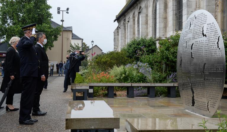 French Interior Minister Gerald Darmanin (3L) pays his respect at the Father Jacques Hamel's memorial next to the church of Saint-Etienne du Rouvray AFP