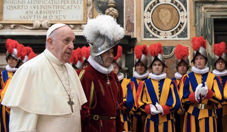 This photo taken and handout on October 2, 2020 by The Vatican Media shows Pope Francis (L) presides over a ceremony in The Vatican's Clementine Hall, for the new Recruits of the Pontifical Swiss Guard. 