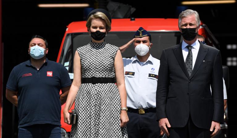 Filip of Belgium (R) and Queen Mathilde of Belgium (2nd L) respect a minute of silence during a tribute ceremony , part of the national mourning day for victims of the severe floods, in Verviers, on July 20, 2021. Belgium's King Philippe and Queen Mathilde paid their respects at the fire station in Verviers, one of the hardest-hit towns. The clean-up is still under way to help the regions hit hardest recover from the scenes of destruction that saw dozens of homes collapsed and cars piled on top of each othe