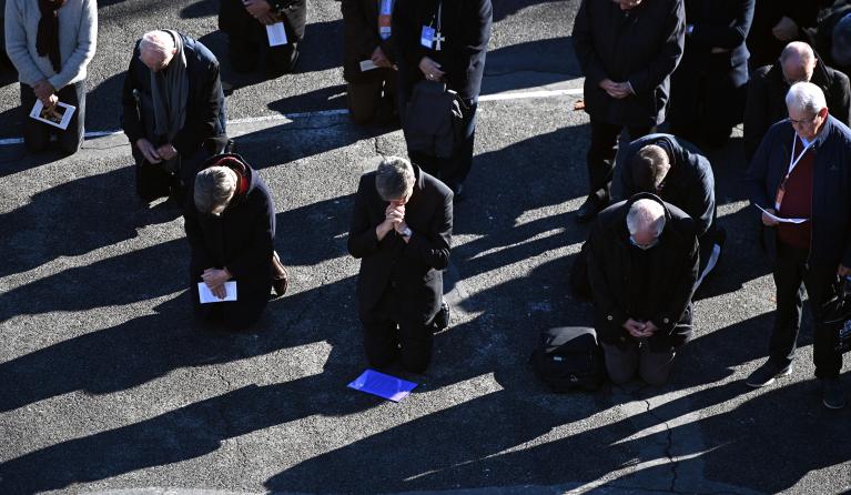 Catholic church bishops kneel as a sign of penance during a ceremony at the sanctuary of Lourdes towards victims of pedocriminality in Lourdes, south-western France on November 6, 2021. The annual meeting of bishops began on November 2, 2021 in Lourdes where they have a week to reflect on the follow-up to be given to the revelations of the Sauve report, a month after its publication, on the extent of child crime in the Catholic Church.
