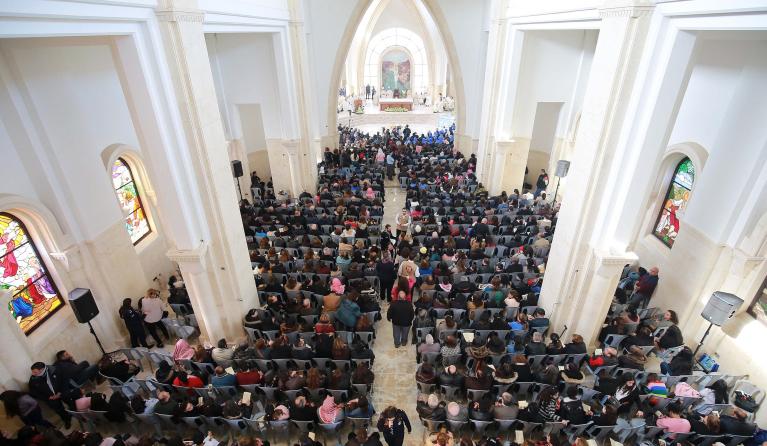 Catholic pilgrims attend a mass at the Church of the Baptism of Christ, near the baptism site of Al-Maghtas, where Jesus is believed by Christians to have been baptised by Saint John, in the Jordan river valley, some 60km southwest of the Jordanian capital Amman, on January 13, 2023. Thousands of Catholic Christians attended the special mass on the banks of the Jordan River in an annual pilgrimage. The event was limited in 2021 to members of the clergy only amid strict restrictions to contain the spread of 