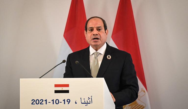 Egypt's President Abdel Fattah El-Sisi delivers a statement (L) after a trilateral meeting between Greece, Egypt and Cyprus, in Athens on October 19, 2021. 