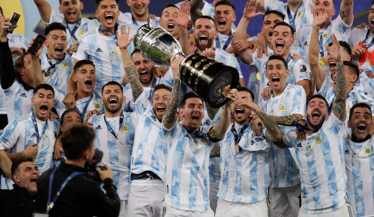 Argentina's Lionel Messi (C) celebrates with the Copa America trophy after the Copa America 2021 final between Argentina and Brazil at the Maracana Stadium in Rio de Janeiro, Brazil, 10 July 2021. 