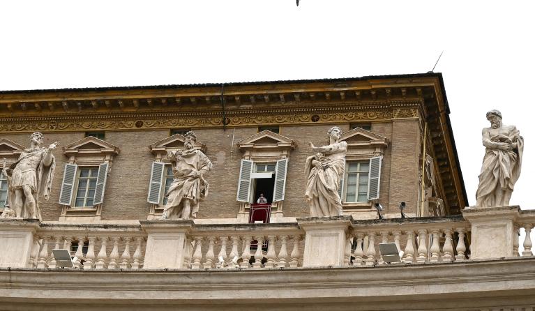 Pope Francis addresses the crowd from the window of the apostolic palace overlooking St.Peter's square during his Sunday Angelus prayer at the Vatican on June 20, 2021. 