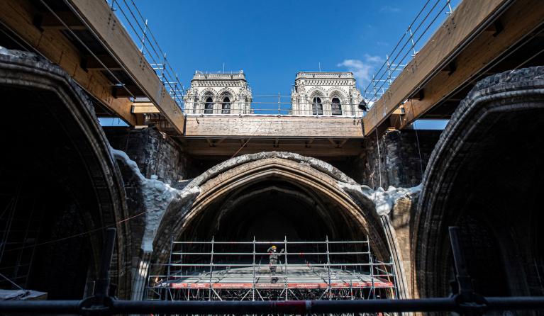 A worker stands on scaffolding under the vault of the Notre-Dame de Paris Cathedral ahead of a visit of French President two years after the blaze that made the spire collapsed and destroyed much of the roof, in Paris on April 15, 2021. The actual restoration work has yet to begin as time up until now has been spent on securing the building, and the full restoration works should begin early next year. 