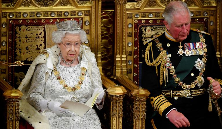 Britain's Queen Elizabeth II (L) sits with Britain's Prince Charles, Prince of Wales on the Sovereign's throne in the House of Lords as she delivers the Queen's Speech at the State Opening of Parliament in the Houses of Parliament in London on October 14, 2019. The State Opening of Parliament is where Queen Elizabeth II performs her ceremonial duty of informing parliament about the government's agenda for the coming year in a Queen's Speech. TOBY MELVILLE / POOL / AFP