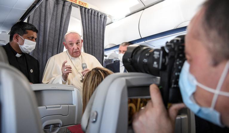 Pope Francis gives a news conference aboard the papal plane on his flight back to Rome after visiting Cyprus and Greece, on December 6, 2021. Pope Francis thanked Greece for its "gracious hospitality" as he left on December 6, 2021 following a landmark three-day visit marked by calls for better treatment of migrants in Europe