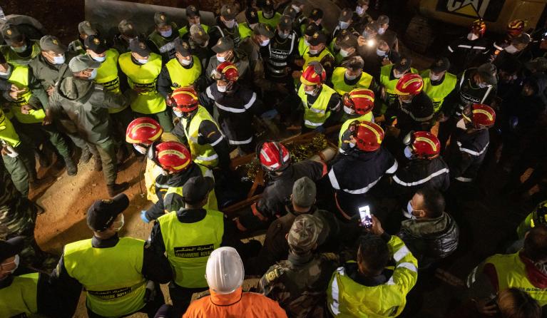 Moroccan emergency services teams carry five-year-old Rayan Oram 
