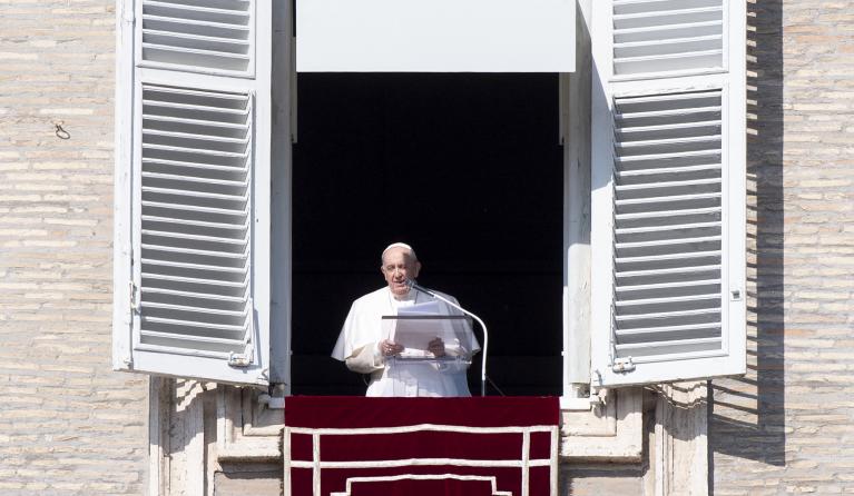 Pope Francis addresses the crowd from the window of the apostolic palace overlooking Saint Peter's square during his Sunday Angelus prayer on February 6, 2022 at the Vatican. 