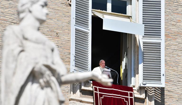 Pope Francis speaks from the window of the apostolic palace during the weekly Angelus prayer on March 20, 2022 in the Vatican. 