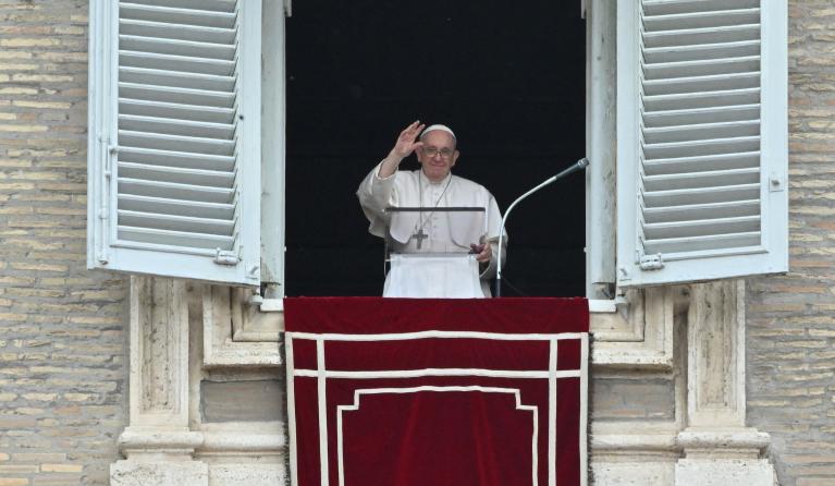 Pope Francis waves from the window of the apostolic palace upon his arrival for the Regina Coeli prayer on May 8, 2022 in The Vatican. 