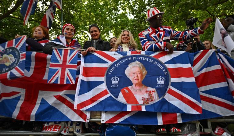 Royal fans line the Mall as they wait for the trooping of the colour as part of Queen Elizabeth II's platinum jubilee celebrations, on June 2, 2022, in London. Huge crowds converged on central London in bright sunshine on Thursday for the start of four days of public events to mark Queen Elizabeth II's historic Platinum Jubilee, in what could be the last major public event of her long reign. 