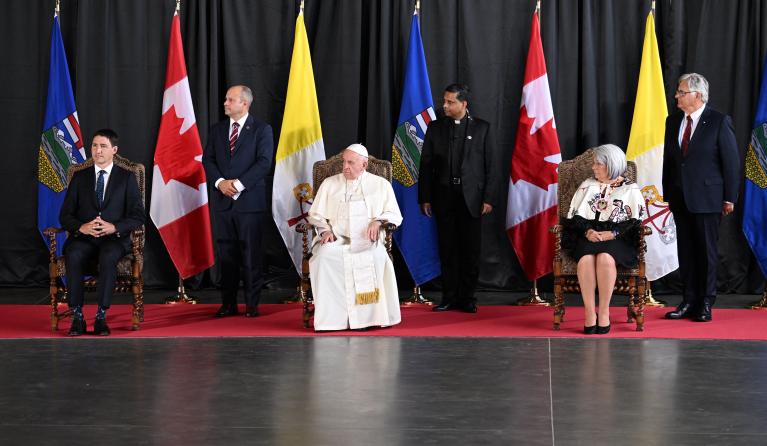 Pope Francis (C) and Canadian Prime Minister Justin Trudeau (L) take part in a welcoming ceremony for the Pope at Edmonton International Airport in Alberta Providence, Canada, on July 24, 2022. Pope Francis visits Canada for a chance to personally apologize to Indigenous survivors of abuse committed over a span of decades at residential schools run by the Catholic Church.
