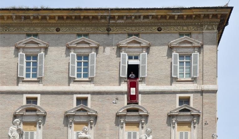 Pope Francis addresses the crowd from the window of the apostolic palace overlooking St.Peter's square during his Sunday Angelus prayer at the Vatican on June 13, 2021.  