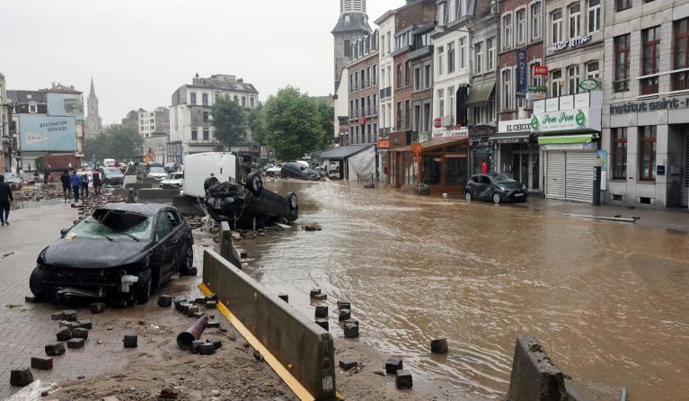 A picture taken on July 15, 2021 shows damaged cars on a flooded street in the Belgian city of Verviers, after heavy rains and floods lashed western Europe, killing at least two people in Belgium. 