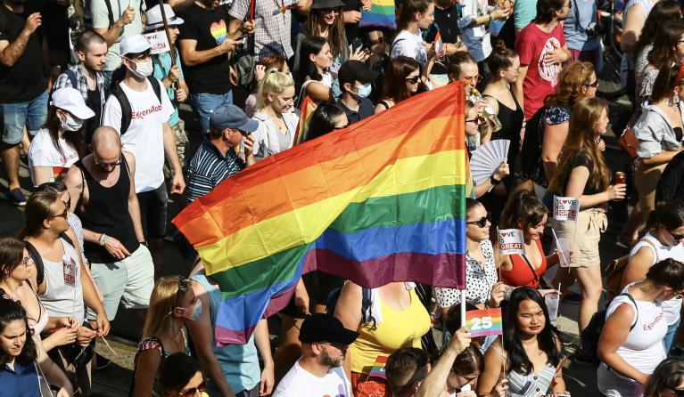 A participant waves a rainbow flag during the lesbian, gay, bisexual and transgender (LGBT) Pride Parade in Budapest on July 24, 2021. 