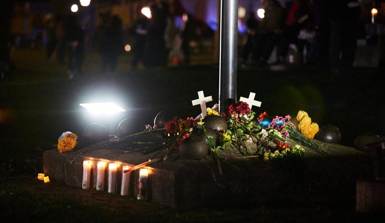 A makeshift memorial is pictured during a candle light vigil in Cutler Park in Waukesha, Wisconsin on November 22, 2021, the day after a vehicle drove through a Christmas parade killing five people. US authorities identified the driver suspected of plowing into a Christmas parade in the Midwestern city of Waukesha, killing at least five and wounding dozens, as media reported he was fleeing a knife fight. The Sunday evening chaos in Wisconsin, which saw a red SUV speed into a crowd of men, women and children