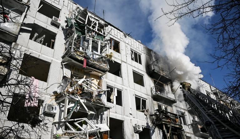 Firefighters work on a fire on a building after bombings on the eastern Ukraine town of Chuguiv on February 24, 2022, as Russian armed forces are trying to invade Ukraine from several directions, using rocket systems and helicopters to attack Ukrainian position in the south, the border guard service said. Russia's ground forces on Thursday crossed into Ukraine from several directions, Ukraine's border guard service said, hours after President Vladimir Putin announced the launch of a major offensive. Russian