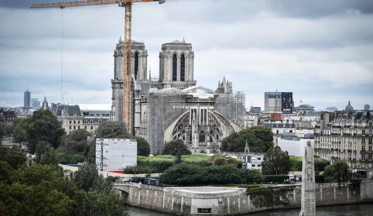 This photograph taken on August 19, 2021 in Paris, shows a giant crane outside Notre-Dame Cathedral, which was partially destroyed when fire broke out