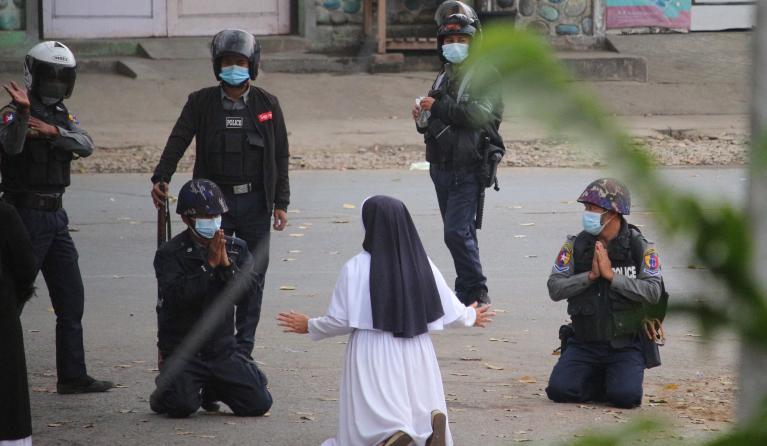 nun pleading with police not to harm protesters in Myitkyina in Myanmar's Kachin state, amid a crackdown on demonstrations against the military coup.  Handout / Myitkyina News Journal / AFP