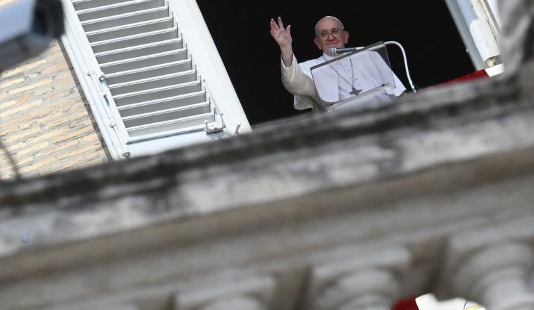 Pope Francis waves as he addresses the crowd during his Angelus prayer from the window of the apostolic palace overlooking St. Peter's Square in The Vatican, on September 11, 2022.