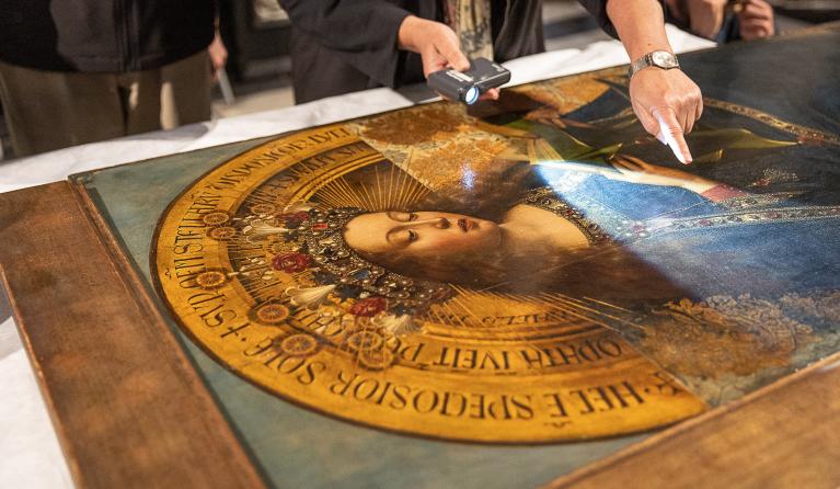 Conservators work on the third phase of the restoration of The Adoration of the Mystic Lamb ("Ghent Altarpiece") created by Belgian painters Hubert and Jan van Eyck in 1432, during a press review in Ghent, on May 2, 2023.